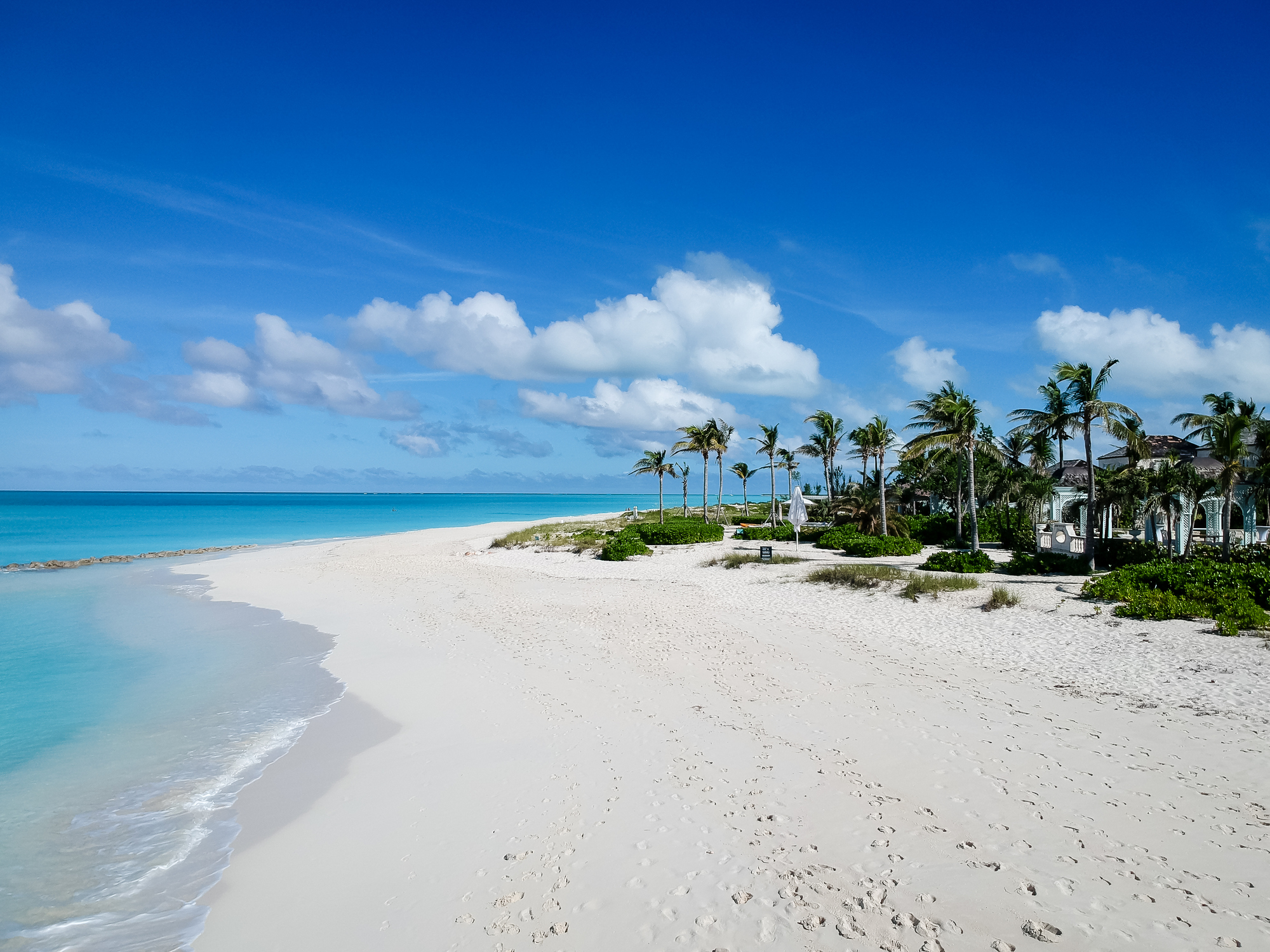 Drone photo of pier in Grace Bay, Providenciales, Turks and Caicos. The caribbean blue sea and white sandy beaches can be seen
